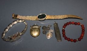 Group of Miscellaneous Jewelry and Two Pocket Knives Description: Group of Miscellaneous Jewelry and Two Pocket Knives, group includes; metal portrait bracelet with bird design on links, red bead bracelet, silver colored bracelet monogrammed "Ja