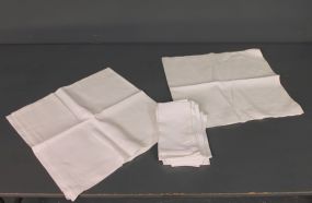 Two White Linen Square Tablecloths Description: Two White Linen Square Tablecloths, one has monograms, 31" square along with ten white linen napkins