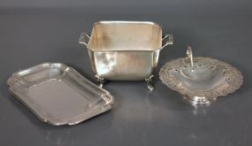Three Silverplate Dishes Description: Three Silverplate Dishes; International Silver Co. footed candy dish (5 1/2" square, 3 3/4" h.) International Silver Co. tray (9" l., 5 1/2" w.), Rogers Bros Candy dish (6" dia., 1 3/4" h.)
