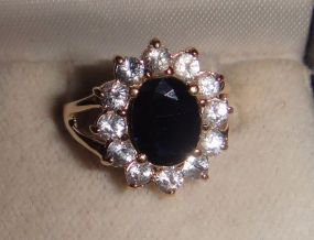 One stamped 14KT yellow gold lady's cast sapphire and aquamarine ring One stamped 14KT yellow gold lady's cast sapphire and aquamarine ring with a split shank with a bright polish finish. Containing: One prong set oval standard brilliant cut nat