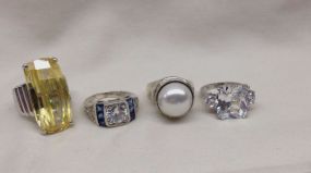 Four Stamped Sterling Silver Lady's Simulated Gemstone Rings Four Stamped Sterling Silver Lady's Simulated Gemstone Rings with a Bright Polish Finish. Sizes vary