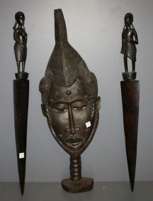  Three Wood Carved African Wall Art Description: Three Wood Carved African Wall Art; carved face 36 1/2" h., 12" w., two carved figures 35" h.