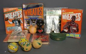  Group of Collectible Items Description: Box lot of collectibles, which in include three boxes of Wheaties (Michael Jordan on cover), bag of plastic face balls, ceramic bamboo nodder, sports books, tin fish bait box.