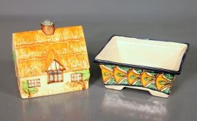  Two Hand Painted Pottery Pieces Description: Two Hand Painted Pottery Pieces; Rectangle dish (7" l., 5 1/2" w., 3" h.) cottage house (6" h., 5 3/4" w., 4 1/2" d.) with green under plate (6 3/4" x 8") Beswickware, England