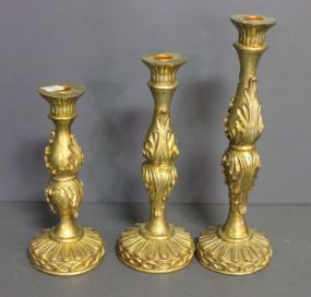  Three Decorative Gold Painted Candlesticks Description: Three Decorative Gold Painted Candlesticks; 14 1/2", 12", 10 1/2" h.