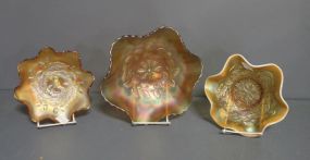  Carnival Glass Bowls Description: Three Carnival Glass Bowls. One acorn and leaves, ruffled edge 7 3/8"dia. One 6 1/2"dia with white ridge on ruffled edge. One 9 7/8", leaf and flower all merigold color.