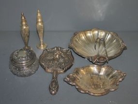  Group of Silverplate Items Description: Lot of 6 Silverplate items, covered powder jar 5"dia. Pair etched salt and Peppers 7 1/2"h., bon-bon dish 9 1/2" oval, Shell bon-bon 10" dia. Victorian hand mirror.