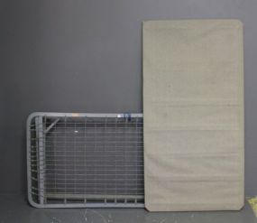  Trundle Bed Description: Iron trundle bed with covered frame, single size.