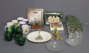  Group of Miscellaneous Christmas Items Description: Box lot of Christmas items which include 12 water glasses, 4 tumblers, cake stand, pair brass candlesticks, 6 mugs, 12 green punch cups.