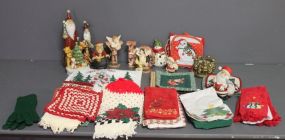  Group of Miscellaneous Christmas Items Description: Box lot of Christmas hand towels, pot holders, and various ceramic figurines.