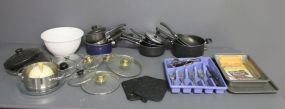  Collection of Cookware Description: Collection of Cookware, 9 saucepans, 1 frying pan, 2 Pyrex glass pieces, 2 cooking trays, set of partial flatware.