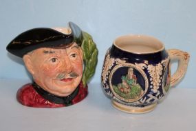  Two Mugs Two Mugs; one Staffordshire character jug 4 1/2" h., one German mug 4" h.
