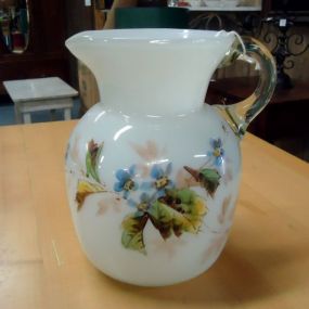  Hand Blown Pitcher Hand blown pitcher with clear handle and blue flower design 8"h.