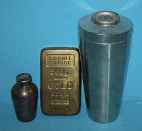  Brass Credit Swiss Paperweight, Small Silverplate Cup and Stainless Steel Cocktail Shaker Brass Credit Swiss Paperweight, Small Silverplate Cup 4"h., and Stainless Steel Cocktail Shaker