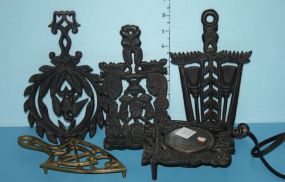  Iron Cup Warmer and Three Iron Trivets along with One Brass Trivet Iron Cup Warmer and Three Iron Trivets along with One Brass Trivet