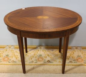 Oval hepplewhite style side table. Hepplewhite style side table with oval inlay in the center and inlay banding on sides and legs; 32" w.,22" d., 24" h.