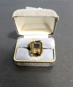 A ladies ring with a smoky quartz stone in a stamped 10 karat mount. Ring is size 7.5