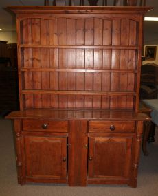 Nineteenth century pine step back cupboard. The top section has shelves with plate rack, apron curved cornice. Base has two drawers over two raised panel doors with columns on each side; 61" w., 17 1/2" d., 80 1/2" h.