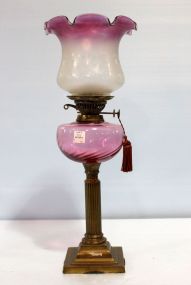 Victorian brass oil lamp with cranberry font. Beautiful oil lamp with ruffled cranberry shade. 22 1/2" h.