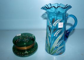 Victorian blue glass pitcher and green powder jar with enamel work. Pitcher, 10" h. ; powder jar, 7" dia.