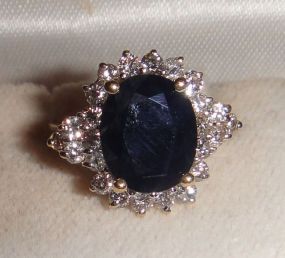 One stamped 14KT yellow gold lady's cast sapphire and diamond cluster ring