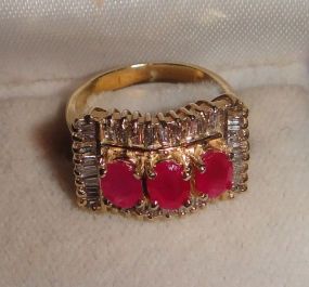 One stamped 14KT yellow gold lady's cast 3 ruby and diamond ring