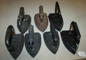 Seven Cast Iron Flat Irons One marked Sheffield; 5" h.