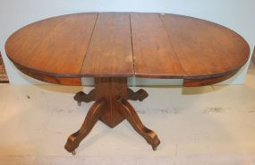 62" Oval Oak Table two leaves in it, 42"d., 30"h., leaves 9"w.