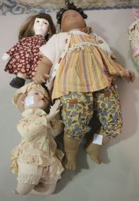 Group of Three Porcelain Dolls One praying boy 11"h., country girl 12"h., black gypsy doll (head busted, needs new head, 21"h.