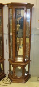 Contemporary Lighted Display Cabinet Contemporary lighted display cabinet with glass shelves. 24"w., 10"d., 70"h.