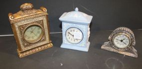 Three Small Clocks, Crystal Clock, Blue Porcelain Clock, and Gold Clock crystal clock 3 1/2" h, porcelain clock 6" h., gold clock 7" h.