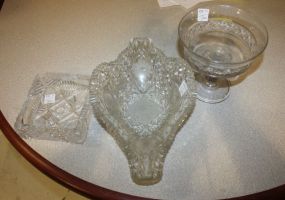 Early Glass Lot Early glass lot consisting of cut glass basket/boat 14"w., cut glass square ashtray 6", press glass compote 6"dia.