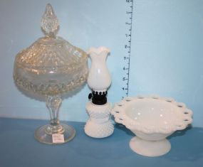 Milk Glass and Covered Dish Milk glass compote 7" dia., small milk glass lamp 8" h., and press glass covered dish 12"h.
