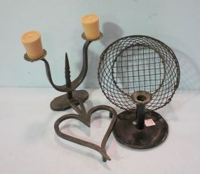 Candlesticks, Trivet and Basket Tin candlestick 5 1/2"h., iron candlestick 8"h., iron heart trivet 9 1/2"h., 6 1/2"w., and wire basket 3 1/2", 8 1/4" dia.