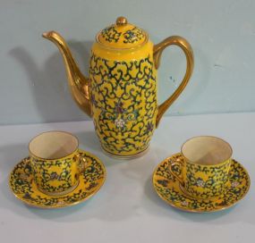 Teapot, Cups and Saucers Yellow porcelain made in Japan teapot 6 1/2"h., and two cups and saucers