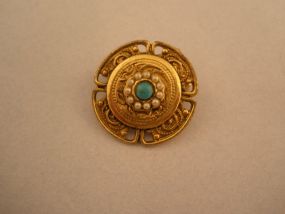 Small Gold Broach with Turquoise Center.