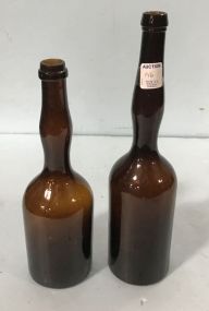 Pair of Tall Amber Ladies Legs Bottles