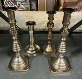 Four Assorted Styled Brass Candle Sticks