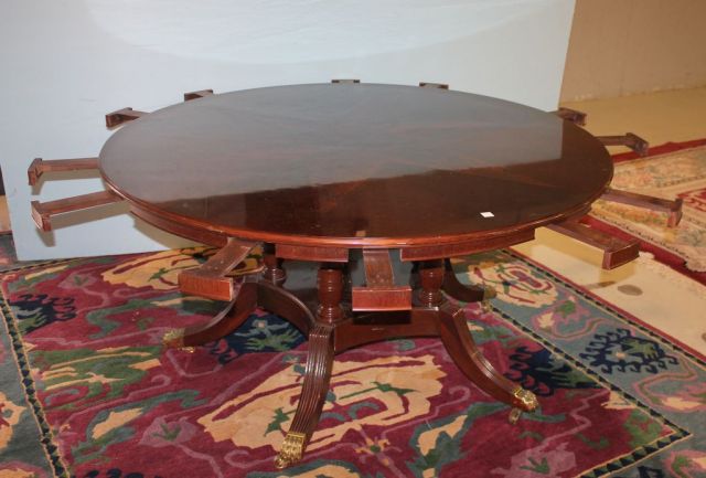 Round Mahogany Starburst Inlaid Dining Table on a Quadruple Pedestal Support with Brass Caps and Castors