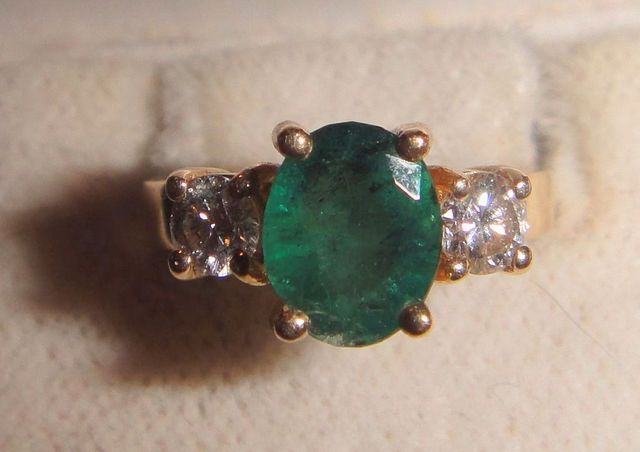 One stamped 14KT yellow gold lady's cast emerald and diamond ring