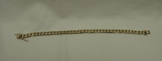 One stamped 10KT yellow gold uni-sex 7.5mm wide, 9" thick curb link bracelet