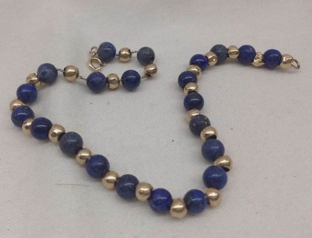 One stamped 14KT yellow gold lady's 7.5" Lapis bead bracelet