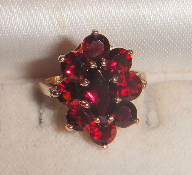 One stamped 14KT yellow gold lady's cast garnet cluster ring