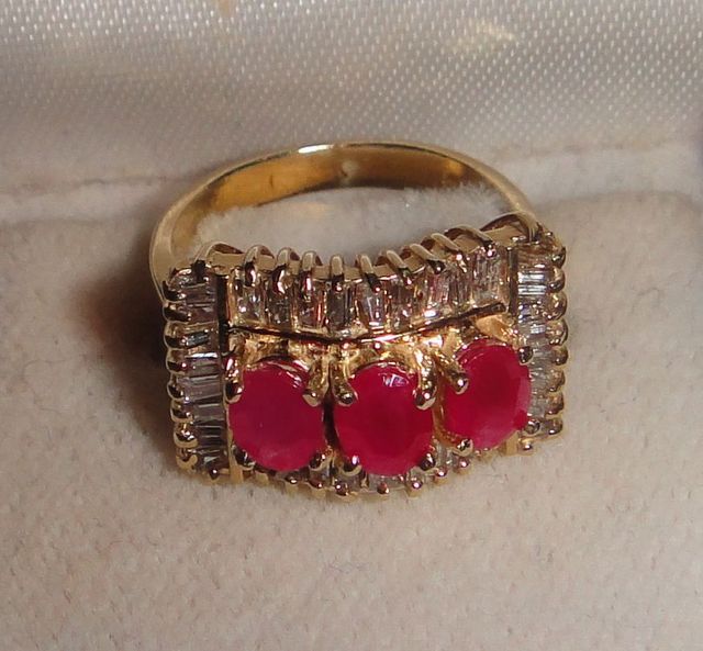 One stamped 14KT yellow gold lady's cast 3 ruby and diamond ring