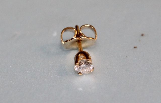 One stamped 14KT yellow gold lady's die struck diamond stud earring