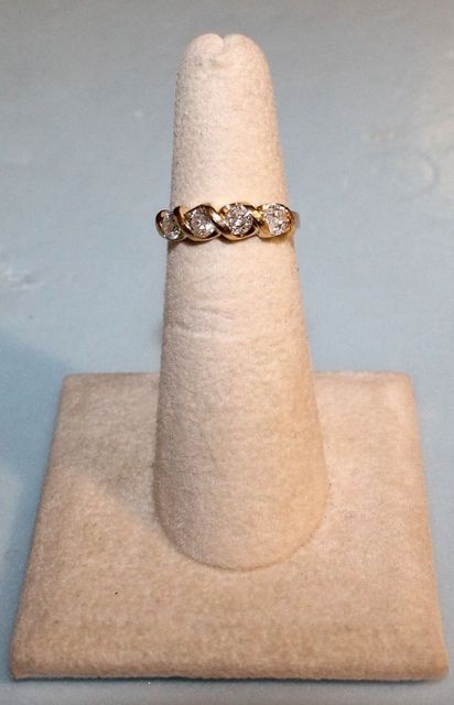 One stamped 14KT yellow gold lady's cast 4 diamond band
