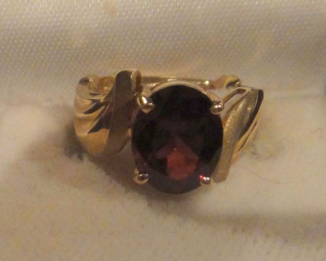 One stamped 14KT yellow gold lady's cast garnet ring