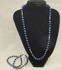 One stamped 14KT yellow gold lady's lapis beaded necklace and two bracelet set with a bright polish finish. Necklace- 18