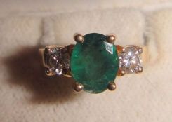 One stamped 14KT yellow gold lady's cast emerald and diamond ring with a half round shank with a bright polish finish. Containing: One prong set oval standard brilliant cut natural emerald, measuring 7.77 x 6.20 x 3.64mm, 10% bulge factor, appro