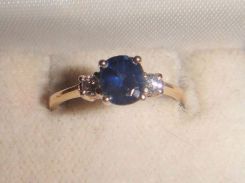 One stamped 14KT yellow gold lady's cast sapphire and diamond ring with a tapered shank with a bright polish finish. Containing: One prong set square cushion standard brilliant cut natural blue sapphire, measuring 5.75 x 5.00 x 3.26mm, 12% bulge